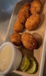 Texas Torpedoes · Smoked pork poppers filled with jalapeno and provolone cheese, with chipotle ranch dressing.