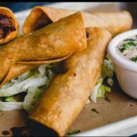 Burnt End Taquitos · Chipotle mashed potatoes, burnt ends, fried in corn
tortillas. Served with shredded lettuce ...