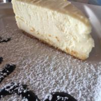 New York Style Cheesecake  · Graham cracker crust and a creamy cheesecake with a hint of lemon, baked to a golden brown.