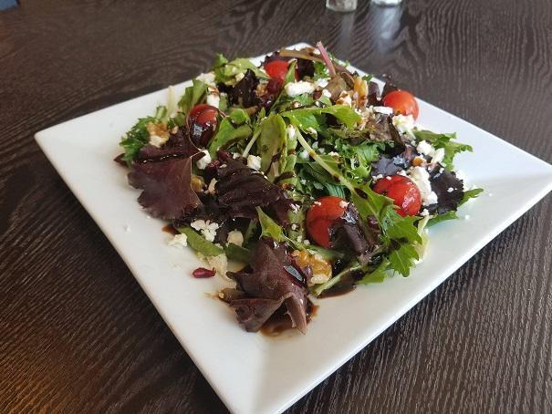 Persian Salad · Mixed greens with dried cranberries, cherry tomatoes, feta cheese, walnuts, and glazed balsamic vinaigrette.