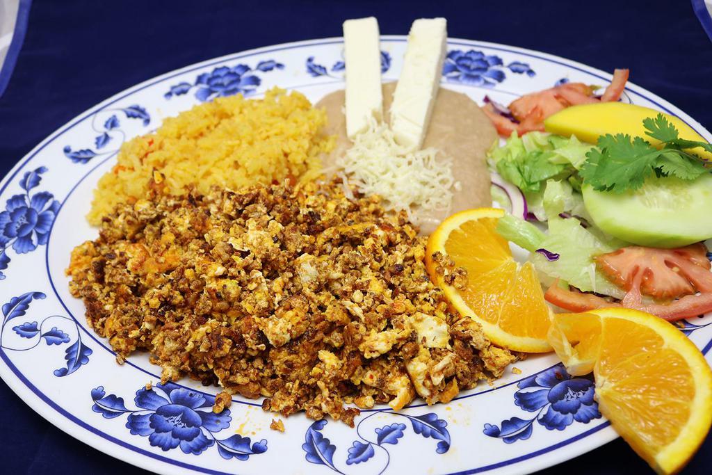 Huevos Con Chorizo · Eggs and Chorizo, three eggs scrambled with tasty Mexican chorizo sausage, served with rice and refried beans topped with cheese.