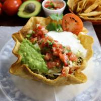 Taco Salad · Hardshell tortilla bowl, filled with your favorite meat choice refried beans, rice, cheese, ...