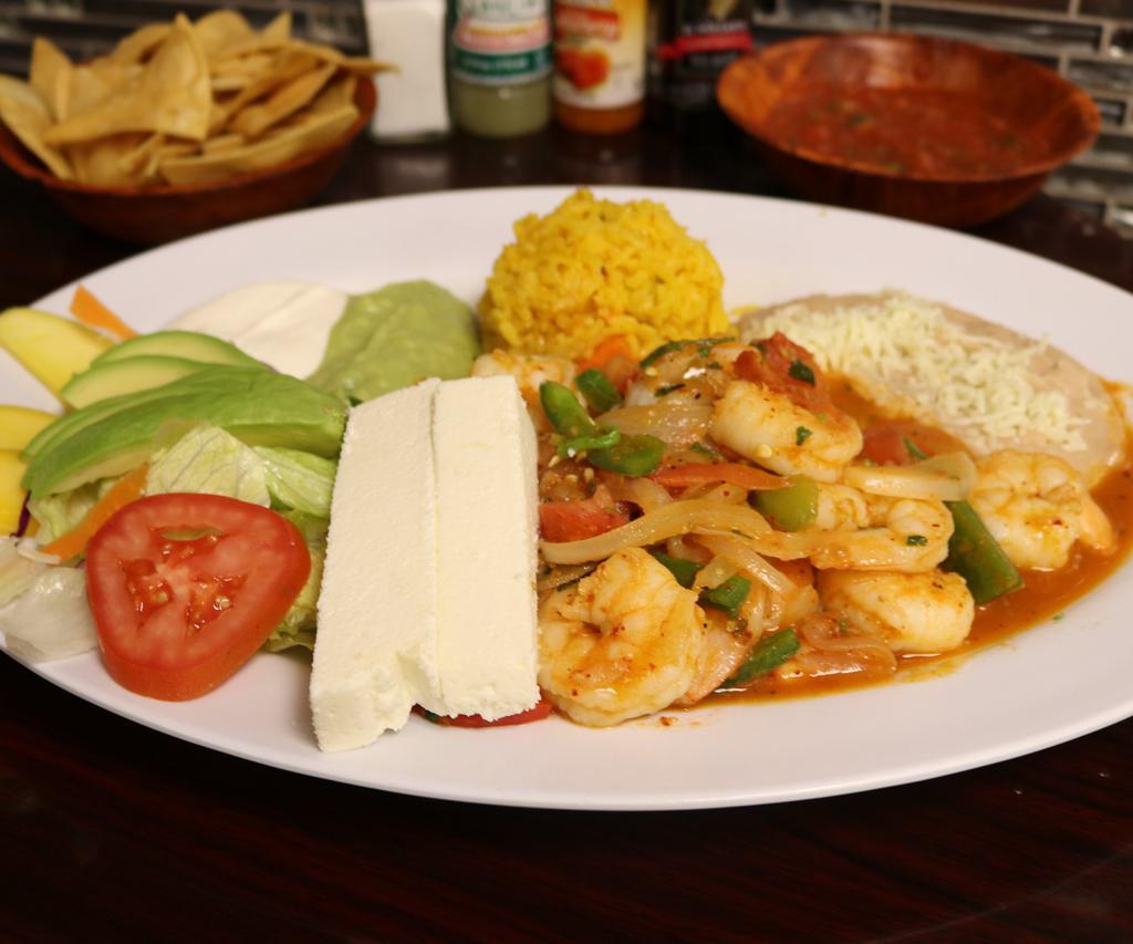 Camarones Rancheros · Delicious jumbo shrimp grilled with fresh jalapeno, onion and tomato served with salad, rice and refried beans, fresh guacamole, and sour cream.