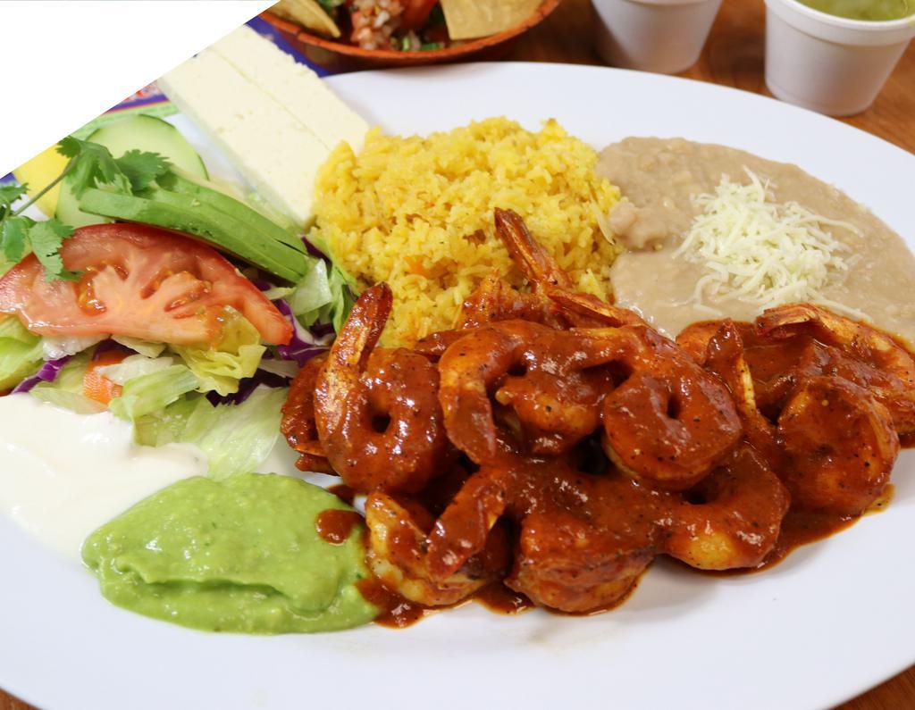 Camarones a la Diabla · Fresh shrimp sauteed with homemade hot sauce, served with salad, rice, refried beans, cheese fresh guacamole, and sour cream.
