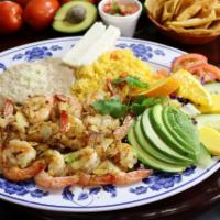 Camarones al Mojo de Ajo · Fresh shrimp sauteed with garlic and salt served with salad, rice, refried beans, cheese, an...
