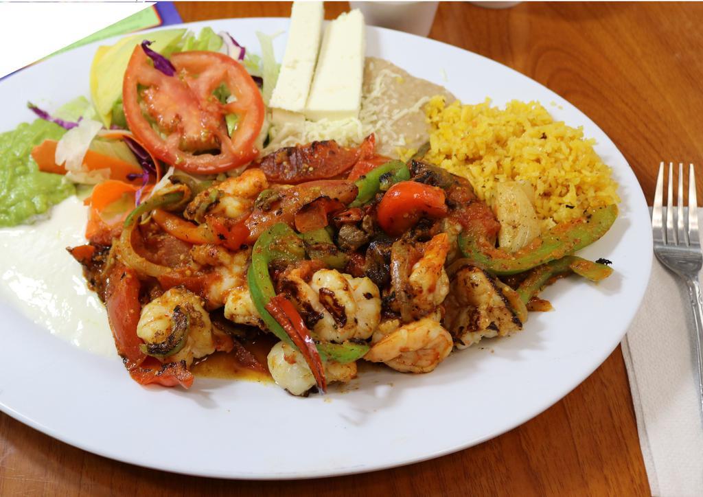 Fajitas De Camaron · Fresh savory shrimp lightly spiced and cooked with red and green bell pepper, onion and tomato, served with salad, refried beans and rice, fresh guacamole and sour cream.