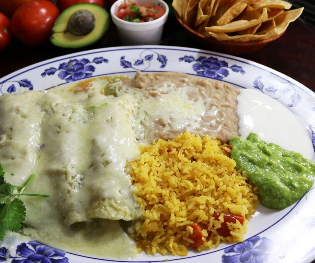 Enchiladas Verdes · 3 rolled corn tortilla filled with your choice of meat topped with our tasty homemade green tomato sauce and cheese, served with salad, rice, refried beans, cheese, fresh guacamole, and sour cream.