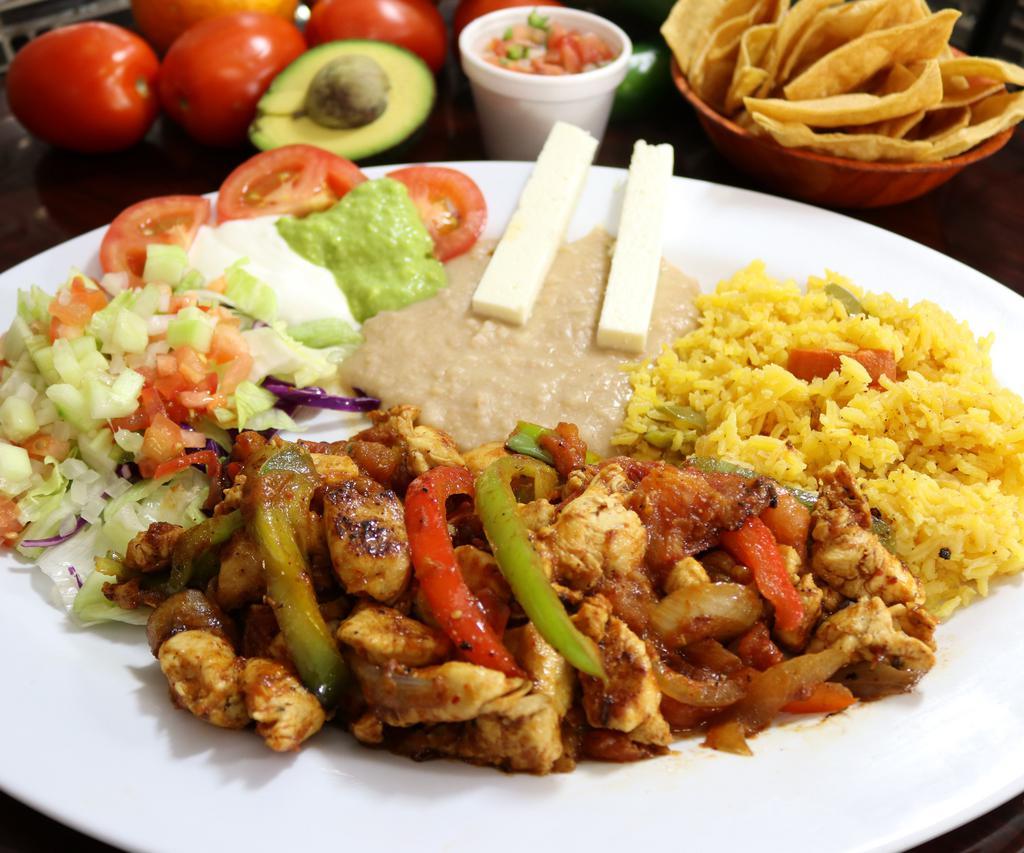 Fajitas de Pollo · Tender thin chicken breast strips slightly spiced and cooked with red and green bell pepper, onion and tomato, served with salad, rice, refried beans, cheese, fresh guacamole, and sour cream.