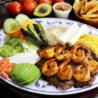 Carne Asada con Camaron · Slightly spiced beef steak and shrimp slowly grilled, served with rice, refried beans, salad...