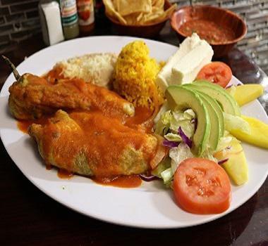 Chile Relleno  · 1 fresh poblano green peppers stuffed with fresh cheese, topped with homemade tomato sauce, served with salad, rice, and refried beans.