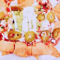 Nachos Regulares · Tortilla chips topped with beans, monterrey and cheddar cheese,Pico de gallo (tomato,onion,j...