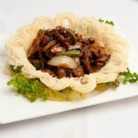 Black Pepper Beef in Bird's Nest ( peppery, hot mild) · Stir-fried peppery spicy beef strips with onion, red peppers and green peppers served in a n...