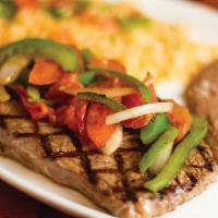 Carne Mexicana · 12 oz. rib eye steak topped with sauteed fajita vegetables. Served with rice, refried beans ...