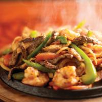 Fajitas · Choice of tender strips of beef, chicken or both. Grilled with onions, tomatoes and peppers.