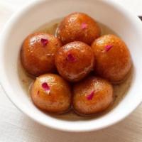 Gulab Jamon · 2 doughy milk balls soaked in light sugar syrup and flavored with green cardamom, saffron an...