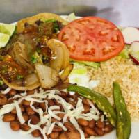 Taco Plate · 2 tacos with the meat of your choice served with rice and whole beans covered in cheese. Inc...