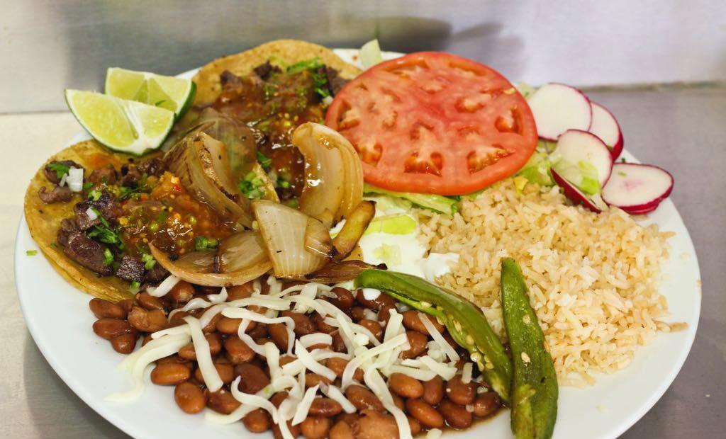Taco Plate · 2 tacos with the meat of your choice served with rice and whole beans covered in cheese. Includes lettuce, tomato, and sour cream.