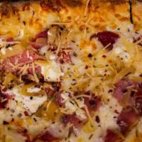 Prosciutto pizza · Caramelized onions, mozzarella cheese, chili flakes, goat cheese, thyme.