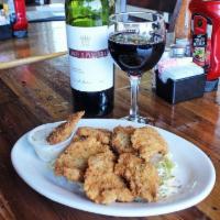Gator Bites · Panko breaded crispy marinated alligator tail served on a bed of serrano slaw with our homem...