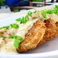 Fried Green Tomatoes · Panko breaded fried green tomatoes topped with a warm crawfish remoulade.