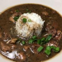 Bowl of Gran Jan's Gumbo · Chicken and sausage in a dark roux over white rice.
