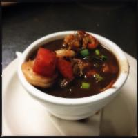 Cup of Ben's Gumbo · Shrimp and crawfish in a dark roux over white rice.