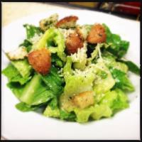 Side Caesar Salad · Romaine, fresh Parmesan, and French bread croutons tossed in homemade Caesar dressing.
