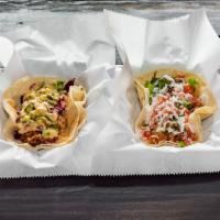Fistful of Tacos · 2 double corn tortilla shells. Choose any 2 flavors below.