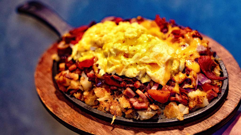 Meat Lover's Skillet · Home fries with chopped bacon, ham, sausage, tomato and cheddar cheese, served with 2 eggs.