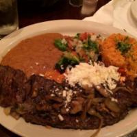 CARNE ASADA · Charbroiled skirt steak topped with grilled Spanish onions and poblano rajas. Served with a ...