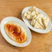 Hummus · Our house made hummus served with warm pita bread.