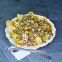 Nachos with Meat · Choice of meat, tortilla chips, beans, cheese sauce, shredded cheddar, onion, cilantro, avoc...