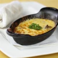 Queso Fundido · Fondue cheese served with warm tortillas.