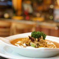 Sopa de Tortilla · A bowl of our traditional chipotle and tomato based tortilla soup topped with avocado, sour ...