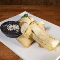 Tamales · 2 Homemade cornmeal tamales wrapped in a cornhusk and filled with choice of style. Served wi...