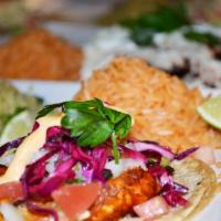 Tacos de Tilapia · 3 Grilled tilapia tacos topped with pickled red cabbage and our pico de gallo. Served with M...