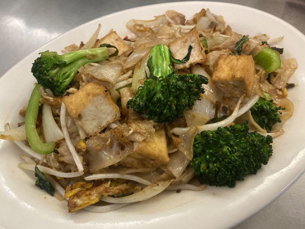 42. Vegetarian Pad Kee Mow · Fresh, flat rice noodles stir-fried with tofu, broccoli, onion, bell pepper, bean sprouts, basil and chili. Spicy.