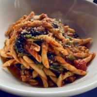 Strozzapreti Pomodoro · Imported hand-rolled long Cavatelli pasta, house sausage, broccoli rabe, pomodoro sauce