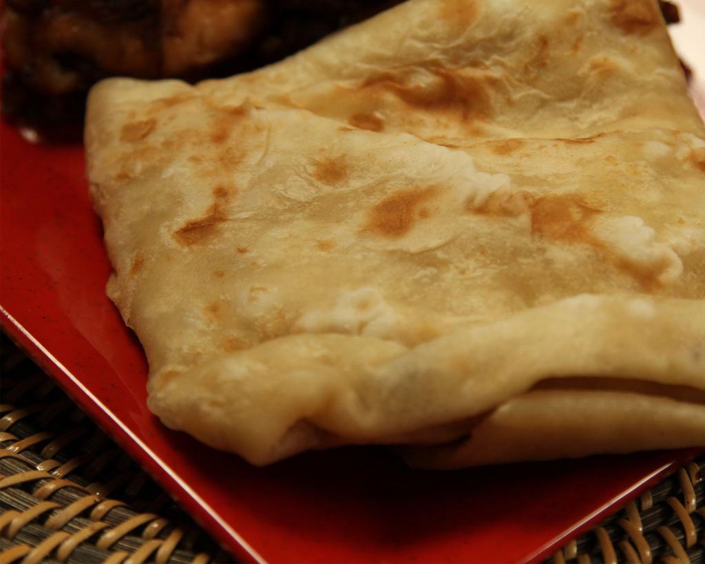 Roti is a side option · No filling. A soft warm wrap seasoned with dried chickpeas or plain, filled with meat or vegetables. Served with a rice and peas, white rice or yellow rice and 1 choice of macaroni and cheese, a garden salad, sauteed cabbage carrots, potato salad, candid yams, or collard greens.