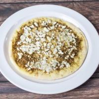 Grilled Pita and Feta · Za'atar and crumbled feta cheese over pita bread and with a drizzle of olive oil.
