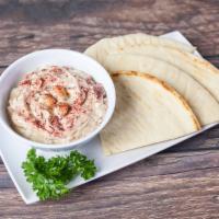 Hummus and Pita · Homemade creamy hummus topped with sumac and olive oil and served with pita bread.