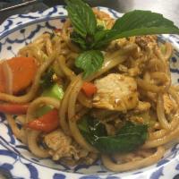 N7. Udon Khee-Mao · Wheat flour udon noodle sauteed smell of basil and garlic with egg, chili, bell pepper, broc...