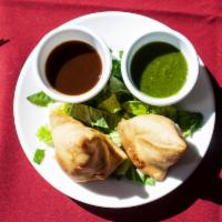Vegetable Samosa · Flaky pastry stuffed with lightly spiced peas and potatoes.