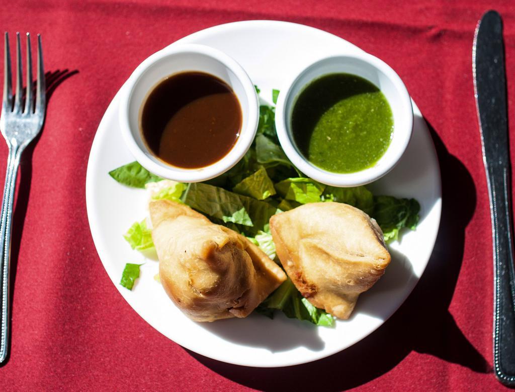 Vegetable Samosa · Flaky pastry stuffed with lightly spiced peas and potatoes.