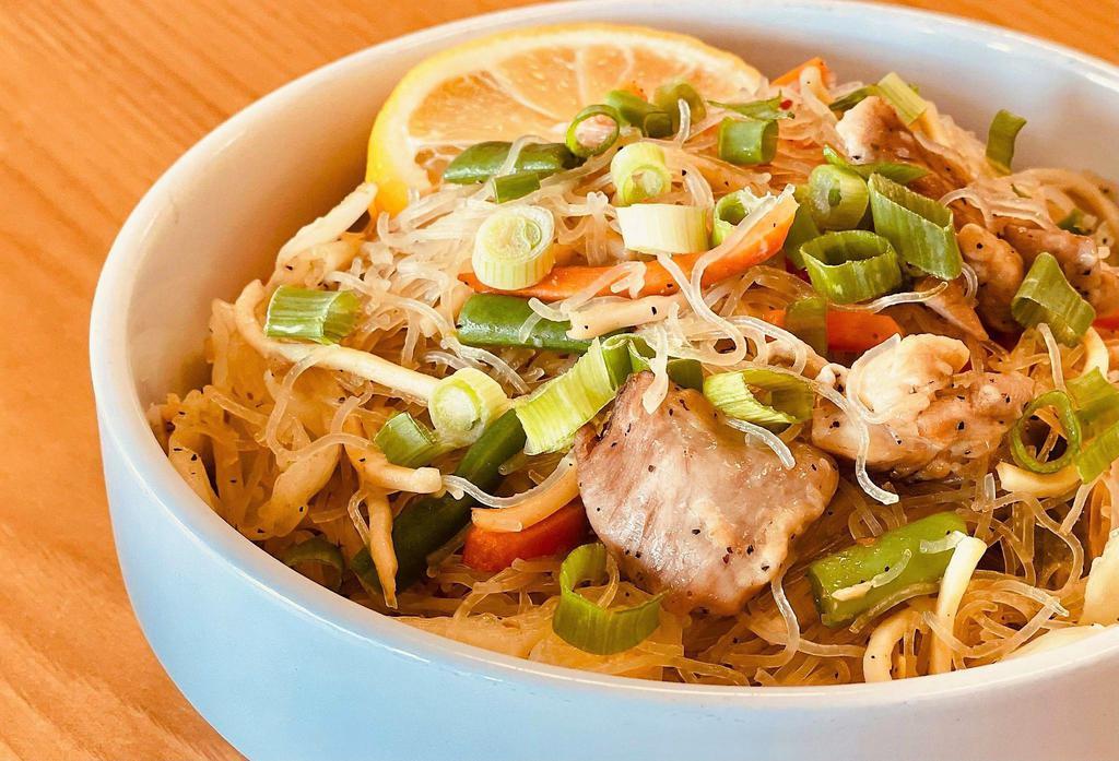 Pancit · Authentic Filipino-style fried noodles made with  rice noodle, chicken, carrots,  and cabbage cooked in  soy sauce, fish sauce and savory spices. 