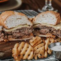 FRENCH DIP · Angus beef thinly sliced in-house, piled high + dipped in hot au jus. Topped with Swiss on a...