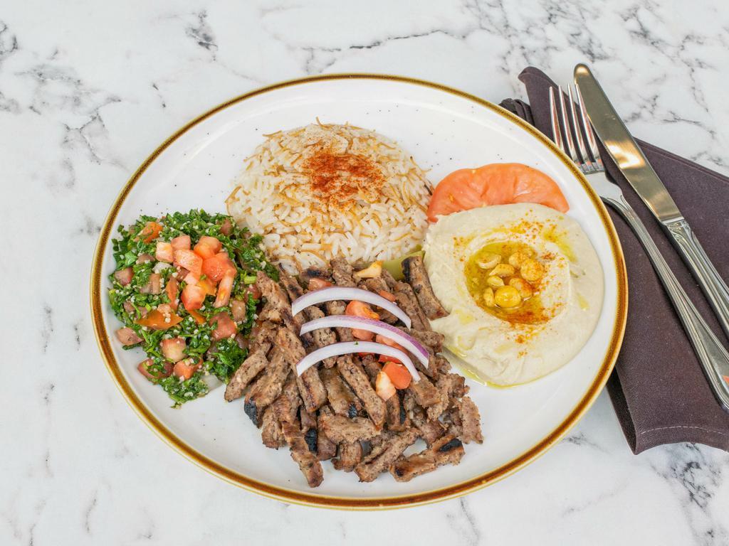 Lamb Gyro Platter · Rice, hummus, Greek salad & tzatziki.