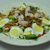 Cobb Salad · Fresh garden greens topped with crispy applewood smoked bacon, gorgonzola crumbs, diced toma...