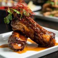 Sticky Ribs · Twice cooked pork ribs tossed with hoisin chili.
