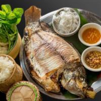 Pla Pao (Grilled whole fish) · Grilled Herbs Whole Tilapia served with fresh vegetables, vermicelli noodle and sticky rice.